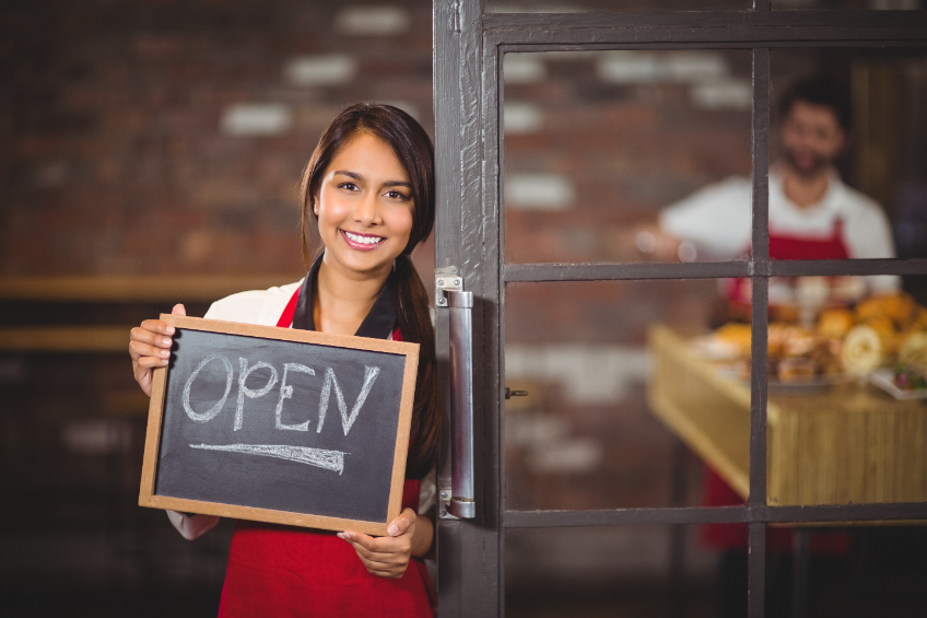 Woman holding an open sign. Legal documents for new businesses