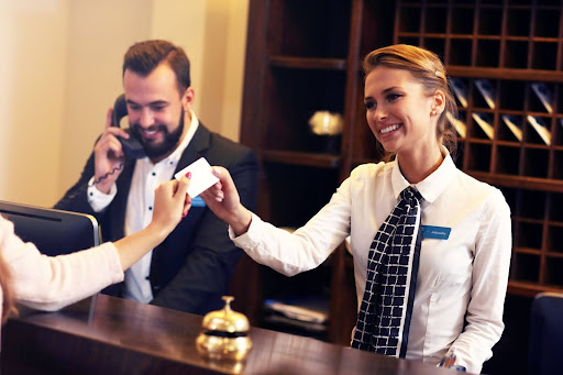 woman at hotel accepting a credit card to represent PCE compliance